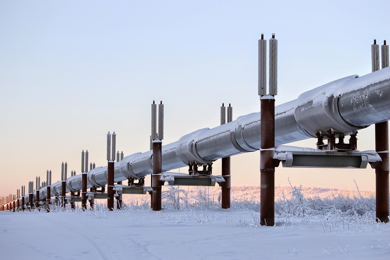 Pipeline with snow on top in an open field